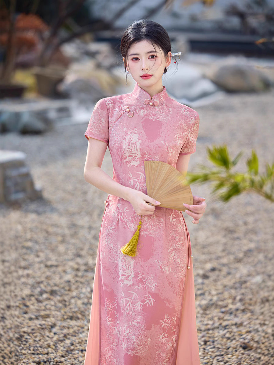 Front view of the Eternal Blush Modern Ao Dai Dress, worn with traditional hair styling and pearl earrings. The embroidery creates a delicate, subtle pattern on the fabric. A refined and timeless Vietnamese silhouette.