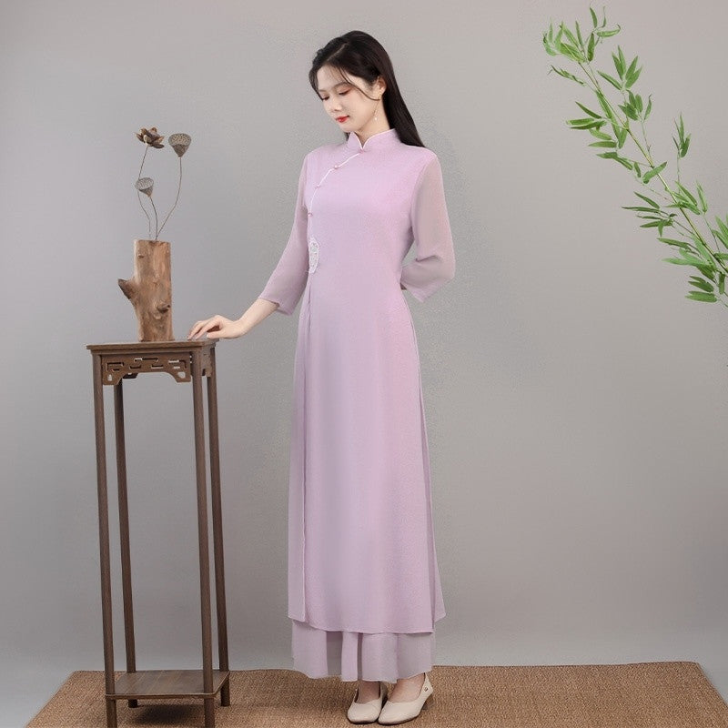 Side-view full-body shot of a model wearing a lavender Lotus Veil Traditional Ao Dai Dress. This Vietnamese ao dai features a flowing layered skirt, high collar, and delicate minimalist elegance, photographed in a calm studio setting with a wooden display stand. A refined and graceful modern ao dai dress look.