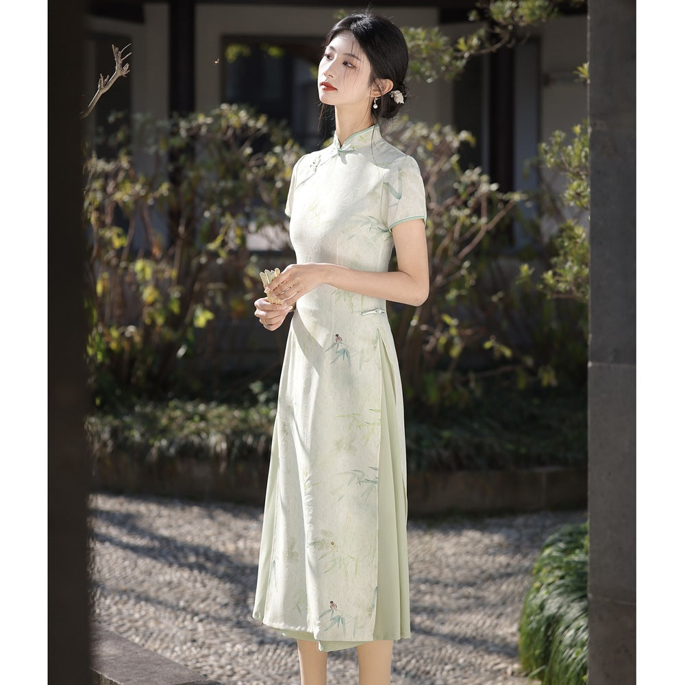 Side-angle mid-shot of a woman wearing the Traditional Velvet Ao Dai Dress under natural sunlight, highlighting its flowing fabric and delicate green bamboo pattern.

