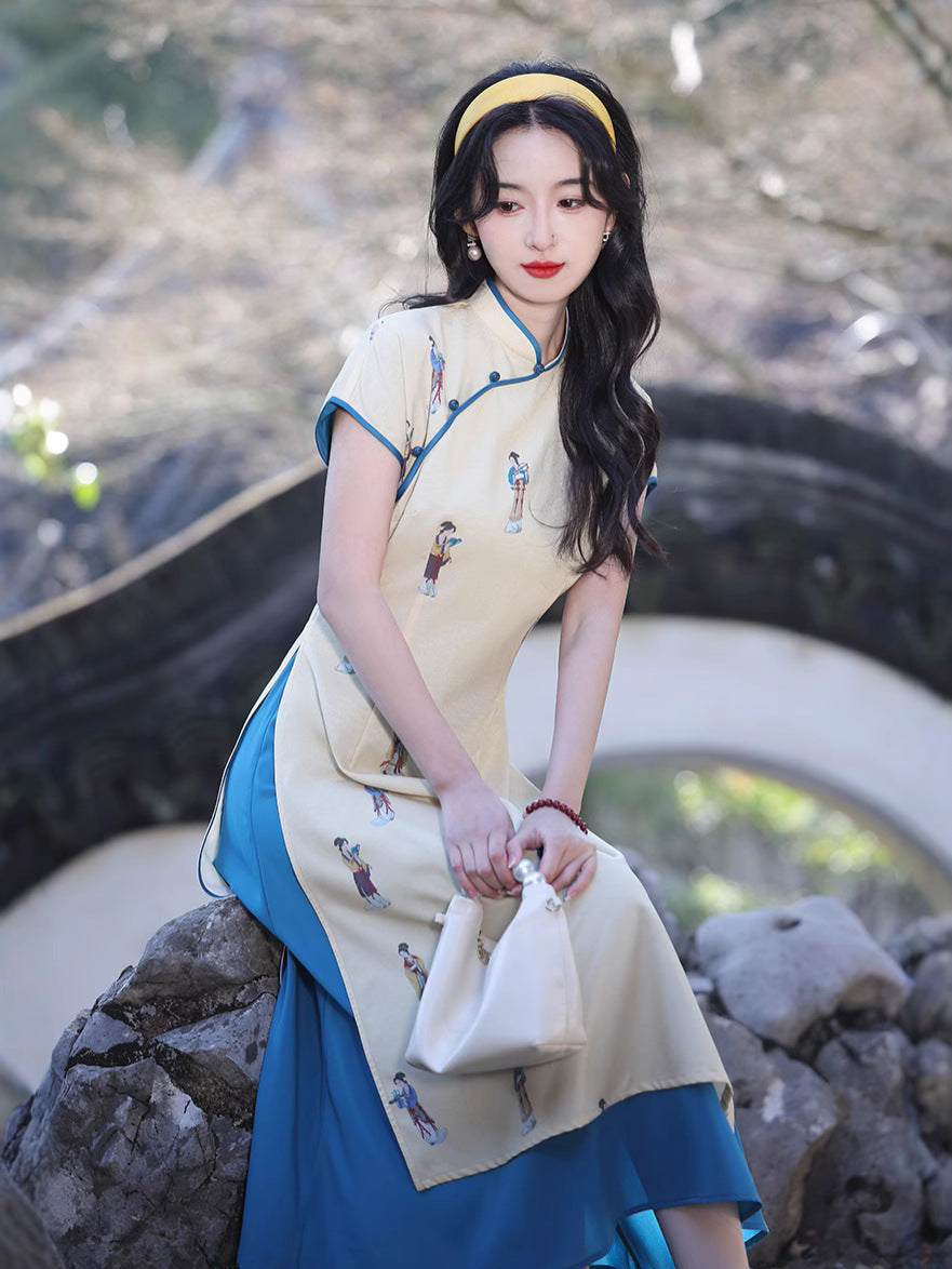 Seated portrait of a woman in the Two-Tone Grace Modern Ao Dai Dress holding a white handbag, photographed among garden stones. The Vietnamese Ao Dai’s soft yellow and teal layers create a graceful dual-tone effect.